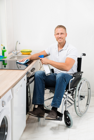 Man on wheelchair cleaning-